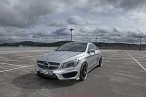 Sleek Silver Mercedes Benz Cla-class Parked On The City Street. Wallpaper