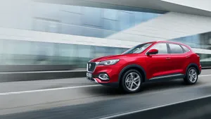 Sleek Silver Mg Sports Car Parked In An Urban Setting Wallpaper