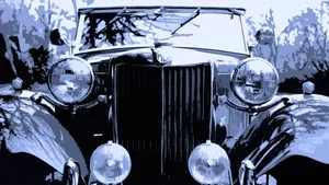 Sleek, Silver Mg Sportscar Parked In Picturesque Landscape Wallpaper