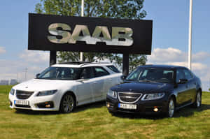 Sleek Silver Saab 9-5 Glistening Under The Sun Wallpaper