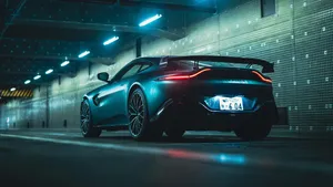 Sleek Sports Car Night Parking Wallpaper