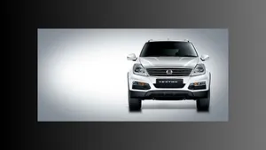 Sleek Ssangyong Suv Driving On A Picturesque Road Wallpaper