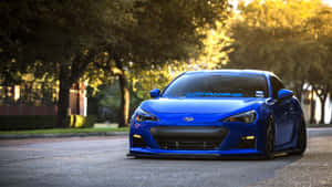 Sleek Subaru Brz Gliding On An Open Road Wallpaper