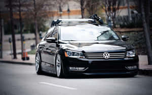 Sleek Volkswagen Passat Cc Cruising On Open Road Wallpaper