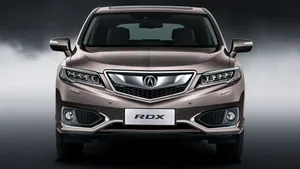 Sleek White Acura Rdx On Scenic Road Wallpaper