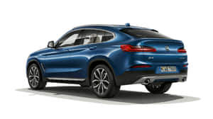 Sleek White Bmw X4 In A Natural Environment Wallpaper