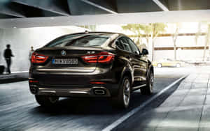 Sleek White Bmw X6 In Movement Wallpaper