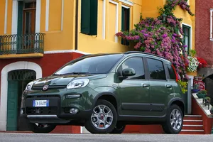 Sleek White Fiat Panda In Scenic Terrain Wallpaper