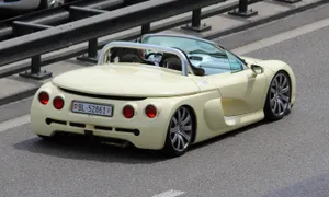 Sleek Yellow Renault Sport Spider On The Racetrack Wallpaper