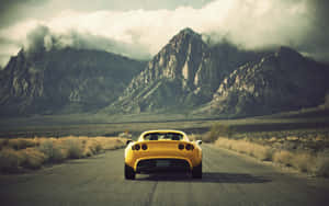 Sleek Yellow Sports Car At Dusk Wallpaper