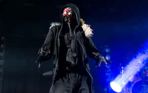 Sleep Token Masked Performer On Stage Wallpaper