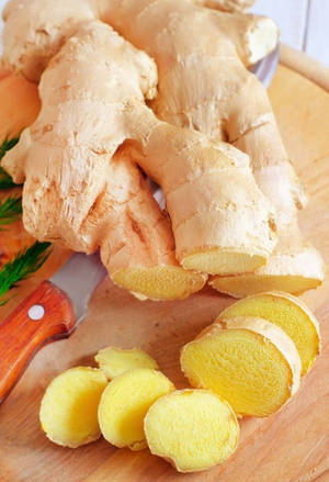 Sliced Ginger Roots Vegetable On Chopping Board Wallpaper