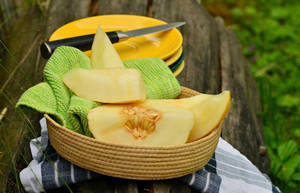 Sliced Honeydew Melon On A Basket Wallpaper