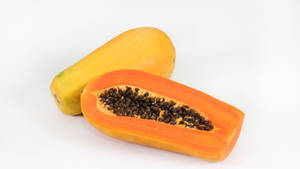 Sliced Papaya Fruits With Seeds White Wallpaper