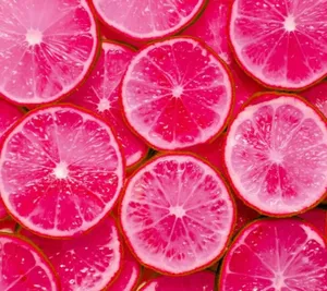 Sliced Pink Grapefruit On A Table Wallpaper