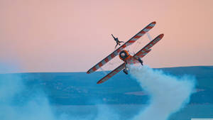 Small Plane With Smoke Wallpaper