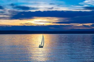 Small Sailing Boat At Dusk Wallpaper