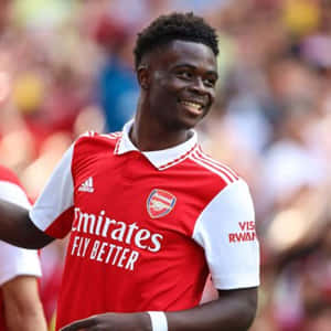 Smiling Arsenal Player Saka Wallpaper