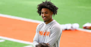 Smiling Athleteat Training Facility Wallpaper