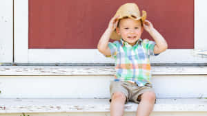 Smiling Boy With Cowboy Hat Wallpaper