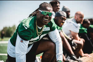 Smiling Football Player Green Uniform Wallpaper