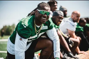 Smiling Football Player Green Uniform Wallpaper