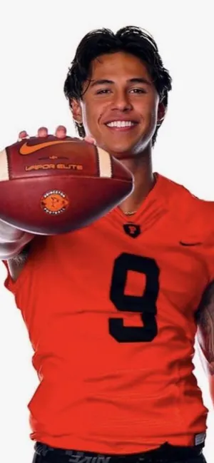 Smiling Football Player Holding Ball Wallpaper