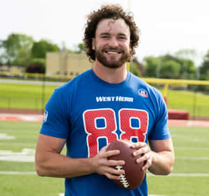 Smiling Football Player Holding Ball Wallpaper