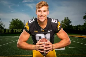 Smiling Football Player Holding Ball Wallpaper