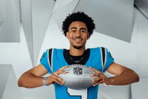 Smiling Football Player Holding N F L Ball Wallpaper