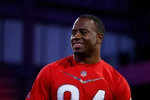 Smiling Football Player Red Jersey Wallpaper