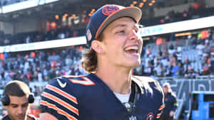 Smiling Football Player Sideline Moment.jpg Wallpaper