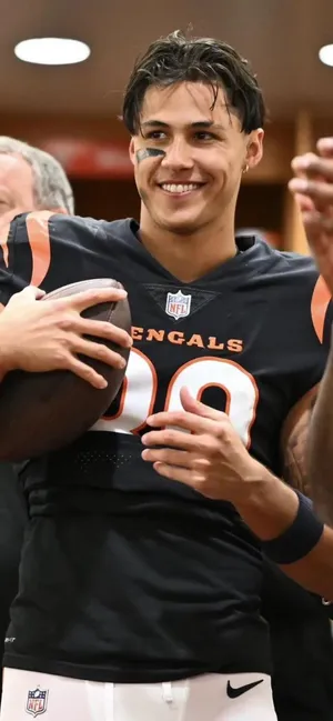 Smiling Football Playerin Locker Room Wallpaper