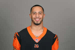 Smiling Football Playerin Orange Black Jersey Wallpaper