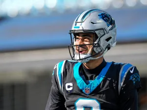 Smiling Football Playerin Panthers Uniform Wallpaper