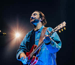 Smiling Guitarist On Stage.jpg Wallpaper