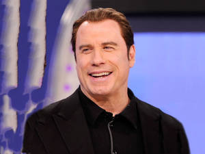 Smiling John Travolta Interview Wallpaper