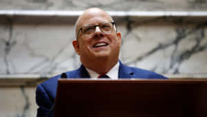 Smiling Man Behind Podium Wallpaper