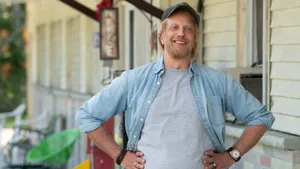 Smiling Man Casual Outfit Standing Outdoors Wallpaper