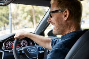 Smiling Man Driving Car Wallpaper