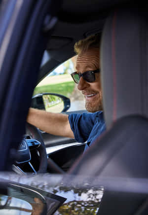 Smiling Man Driving Car Wallpaper