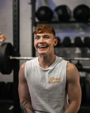 Smiling Man Gym Workout Wallpaper