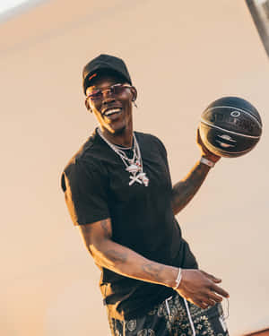 Smiling Man Holding Basketballat Sunset Wallpaper