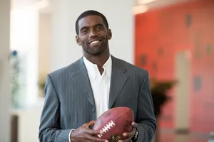 Smiling Man Holding Football Wallpaper