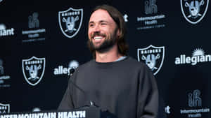 Smiling Man Press Conference Raiders Background Wallpaper