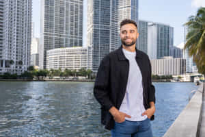 Smiling Man Urban Waterfront Backdrop Wallpaper