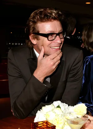 Smiling Man With Glassesat Event Wallpaper