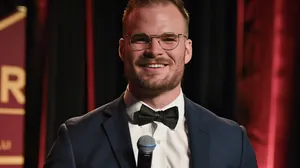 Smiling Manin Tuxedoat Event Wallpaper