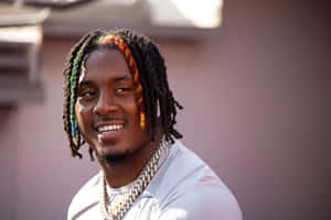 Smiling Manwith Colorful Dreadlocks Wallpaper