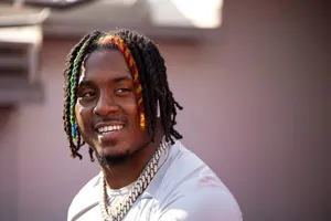 Smiling Manwith Colorful Dreadlocks Wallpaper